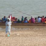 Boat loads of women & children heading out to an island shrine 